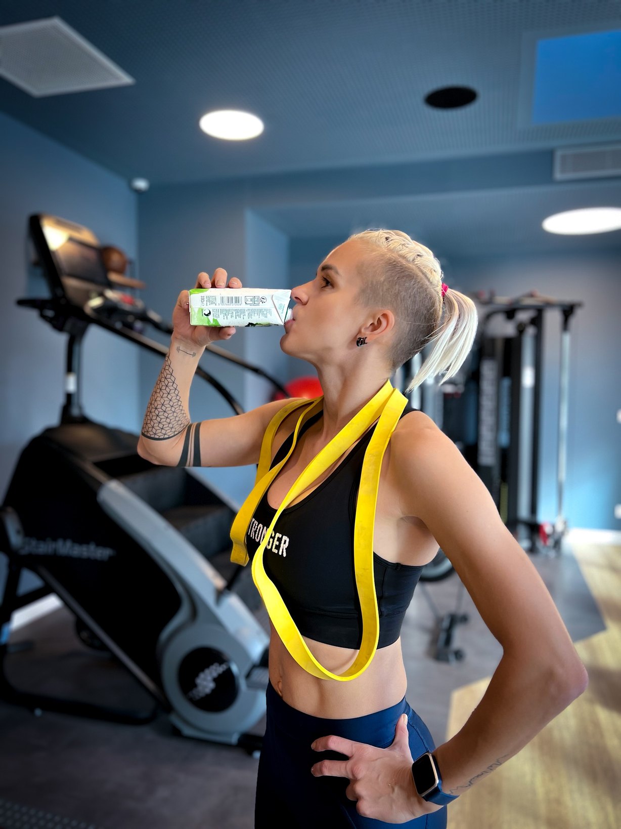 Olga in the gym, taking a break with a drink after training