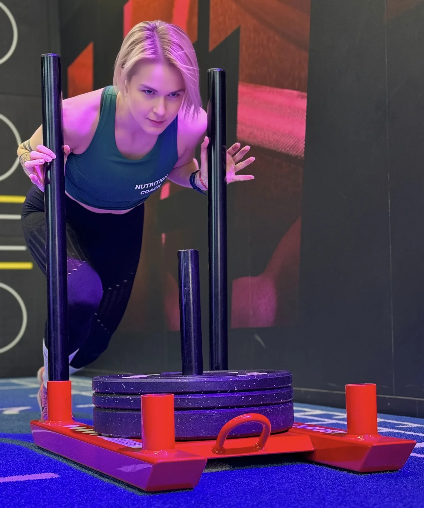 Olga pushing a weighted sled during a training session