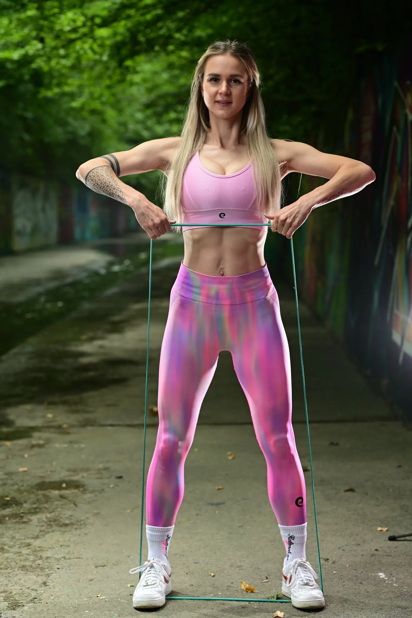 Olga training outdoors in a park with a resistance band